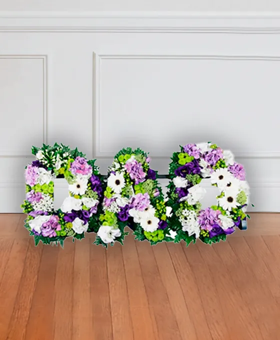 Purple floral letter tribute arranged by hand