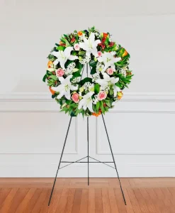 White and green funeral wreath on a stand White and green funeral wreath on a stand